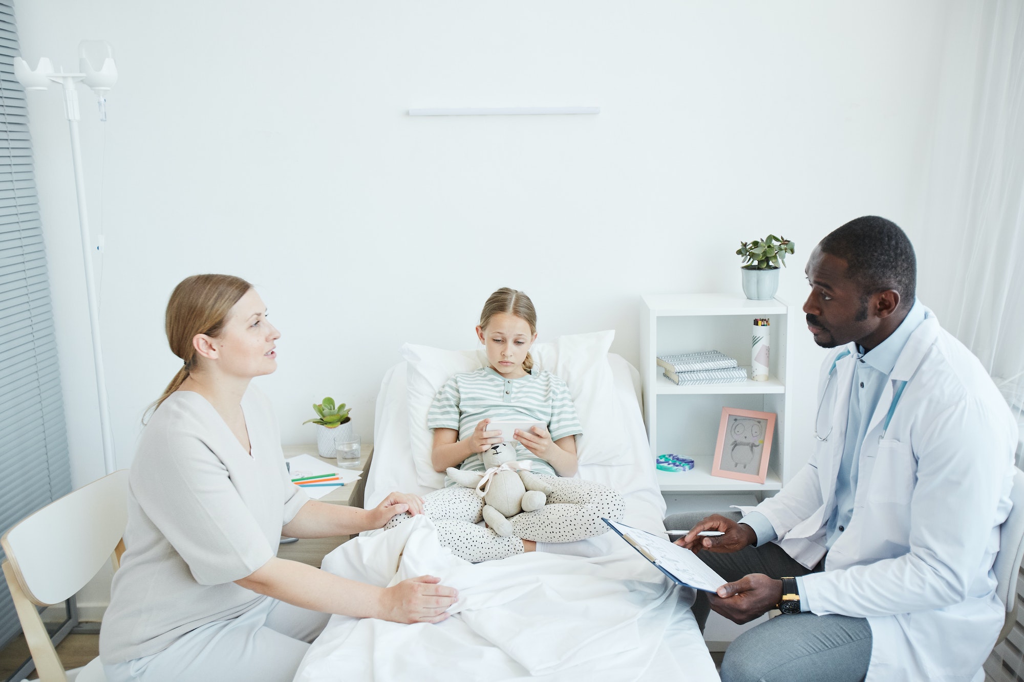 African American Doctor Talking to Parent in Hospital